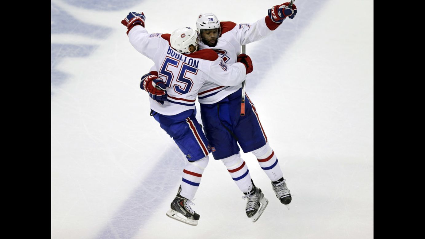 Montreal Canadiens defenseman Francis Boullion leaps into the arms of teammate P.K. Subban on Thursday, May 1, after Subban scored the game-winning goal against Boston in Game 1 of their NHL playoff series. The goal came in the second overtime period.