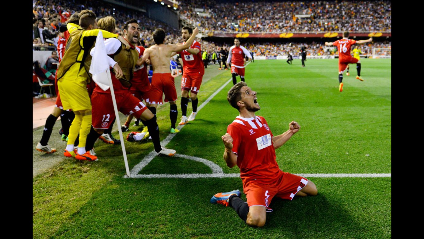Daniel Carrico, bottom, and his Sevilla teammates celebrate a goal Thursday, May 1, that would clinch their spot in the final of the Europa League soccer competition. Sevilla lost the match to Valencia 3-1, but Stephane Mbia's late goal in stoppage time meant Sevilla would advance on away goals. Sevilla had already beaten Valencia 2-0 in the first leg of the semifinal. 