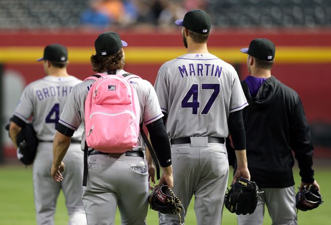 Tommy Kahnle, a rookie pitcher with the Colorado Rockies, wears a pink backpack as he walks to the bullpen before a Major League Baseball game against the Arizona Diamondbacks on Wednesday, April 30.