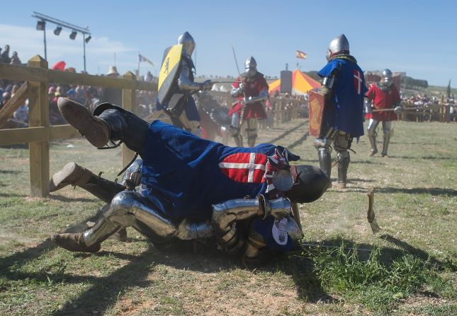A knight of the Danish team falls on top of a knight from the Polish team during the International Medieval Combat event Thursday, May 1, in Belmonte, Spain. The contact sport uses blunt weapons and is based on the medieval tournaments of the 14th and 15th centuries.