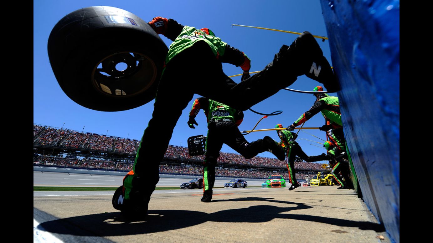 The pit crew of Danica Patrick jumps over the wall Sunday, May 4, during the NASCAR Sprint Cup race in Talladega, Alabama. Patrick finished 22nd in the race, which was won by Denny Hamlin.