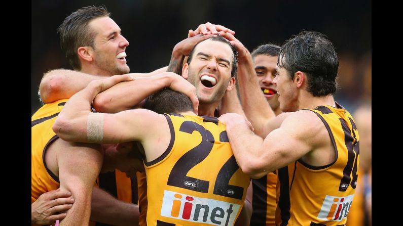 Jordan Lewis of the Hawthorn Hawks is congratulated by teammates after kicking a goal against the St. Kilda Saints during an Australian Football League match won by the Hawks on Saturday, May 3, in Melbourne. It was Lewis' 200th match with the team.