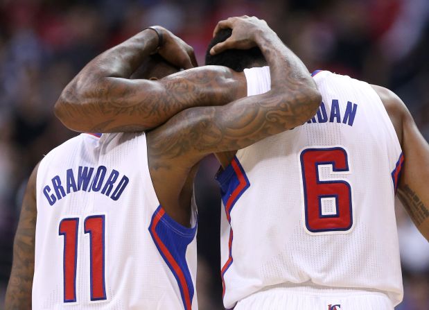 Jamal Crawford and DeAndre Jordan, two players with the NBA's Los Angeles Clippers, embrace Tuesday, April 29, during the final minute of a playoff game against the Golden State Warriors. The Clippers won the game hours after NBA Commissioner Adam Silver banned their owner, Donald Sterling, for racist remarks. The Clippers would later go on to win the series in seven games.