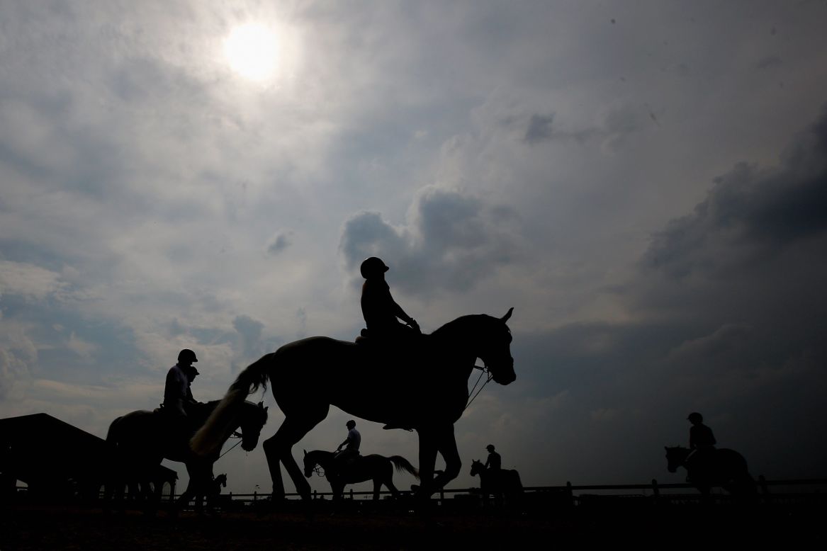 Riders and their horses warm up in the paddock during the Global Champions Tour of Antwerp in Belgium.