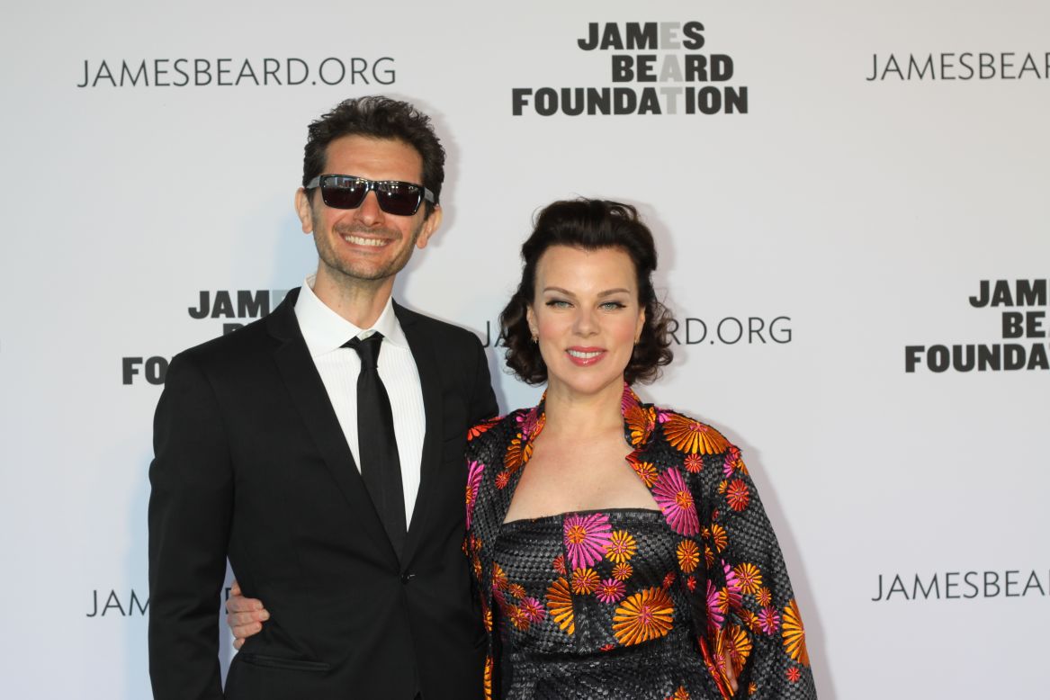Gabriele Corcos and Debi Mazar of the show 'Extra Virgin' walk the red carpet at the James Beard Awards.