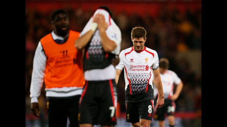 A dejected Steven Gerrard of Liverpool walks off the pitch following his team's 3-3 draw against Crystal Palace in London on Monday, May 5. The result means Manchester City is now the favorite to win the Premier League title. <a href="index.php?page=&url=http%3A%2F%2Fwww.cnn.com%2F2014%2F04%2F29%2Fworldsport%2Fgallery%2Fwhat-a-shot-0429%2Findex.html">See 37 amazing sports photos from last week</a>
