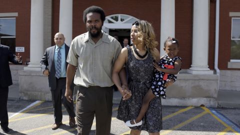 Cornealious "Mike" Anderson walks out of the Mississippi County Courthouse along with his wife LaQonna Anderson, right, their daughter Nevaeh, 3, and his attorney Patrick Megaro, left, Monday, May 5, 2014, in Charleston, Mo.