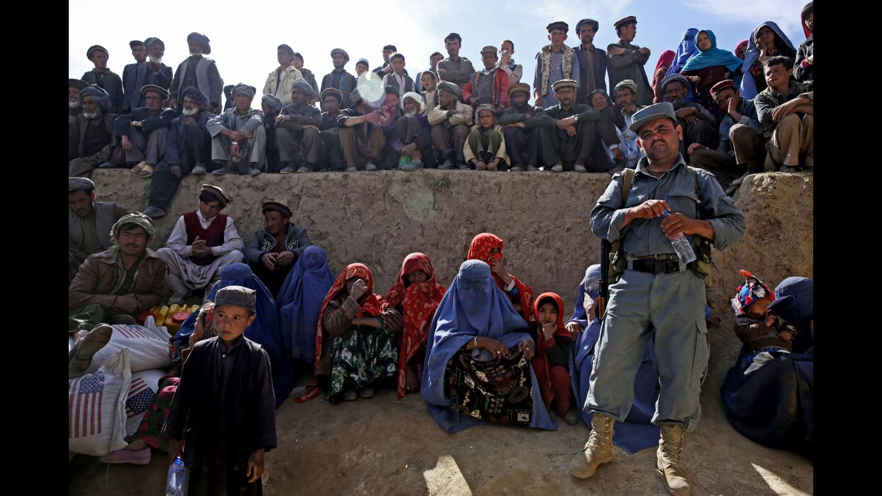 Afghan survivors wait for food donations Tuesday, May 6, near where a double landslide struck in the northeastern province of Badakhshan. More than 2,000 people were killed when a mass of rock and mud came crashing down Friday, May 2, in the village of Abi Barak.