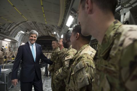 Kerry talks with the crew of a U.S. Air Force plane prior to departure from Addis Ababa, Ethiopia, on Friday, May 2,  2014. He was en route to Juba, South Sudan, to demand a cease-fire in the brutal civil war that has sparked dire warnings of genocide and famine.