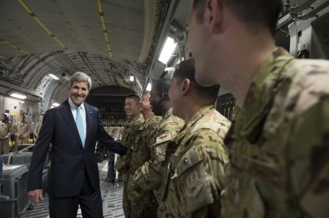 Kerry talks with the crew of a U.S. Air Force plane prior to departure from Addis Ababa, Ethiopia, on Friday, May 2, 2014. He was en route to Juba, South Sudan, to demand a cease-fire in the brutal civil war that has sparked dire warnings of genocide and famine.