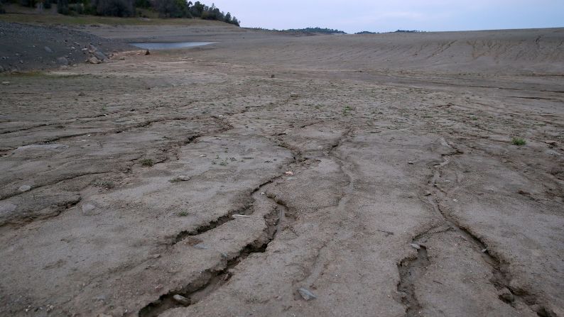 The Great Plains could experience heavier droughts and heat waves with increasing frequency, while more wildfires in the West could threaten agriculture and residential communities, the report notes. In this image, dry and cracked earth is visible on what used to be the bottom of Folsom Lake on March 20, in El Dorado Hills, California.
