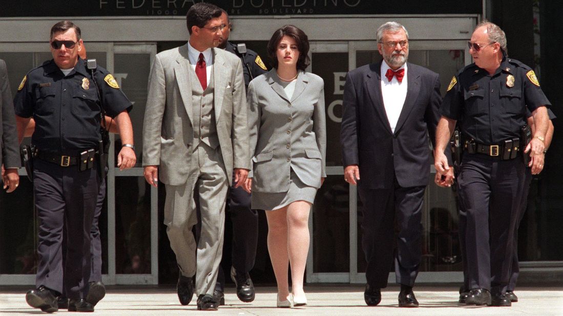 Lewinsky is escorted by police officers, federal investigators and attorney William Ginsburg, second right, as she leaves the Federal Building in Westwood, California, in 1998. She was there submitting evidence on her relationship with Clinton, who was impeached by the House of Representatives on charges of perjury and obstruction of justice. He was later acquitted.