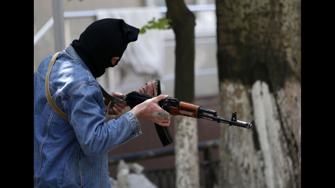 A pro-Russian gunman holds his weapon while guarding the local administration building in Slovyansk on May 6.