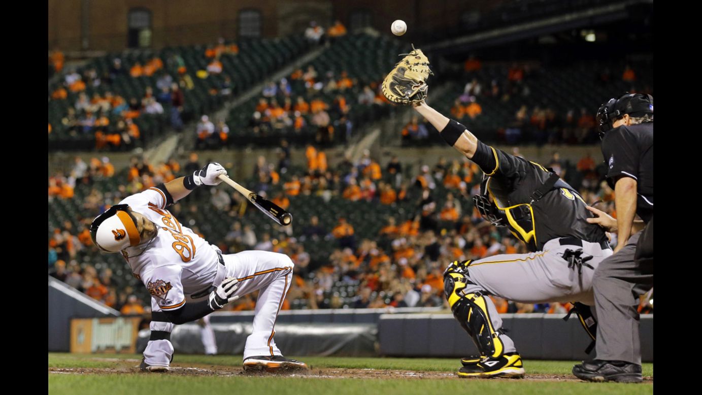 Baltimore's Manny Machado ducks Thursday, May 1, as Pittsburgh catcher Tony Sanchez tries to catch a wide pitch during a Major League Baseball game in Baltimore. Machado and the Orioles won both games of a doubleheader that day.