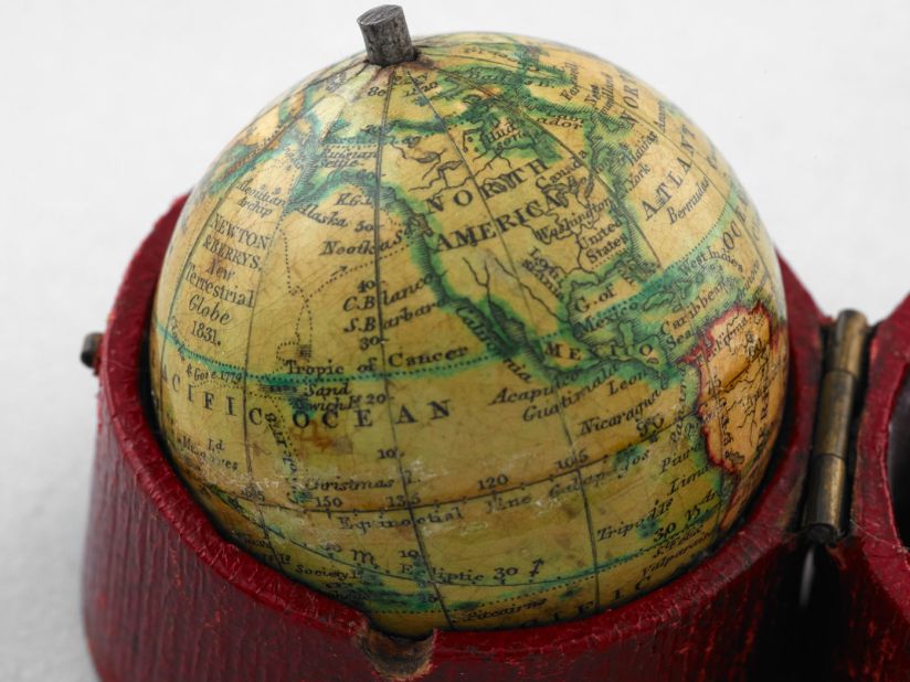 This tiny pocket globe made in 1831 is just 1.5 inches in diameter. Dotted lines trace voyages by Captain Cook and other explorers.