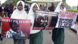 School pupils hold signs as members of Lagos based civil society groups hold rally calling for the release of missing Chibok school girls at the state government house, in Lagos, Nigeria, on May 5, 2014.