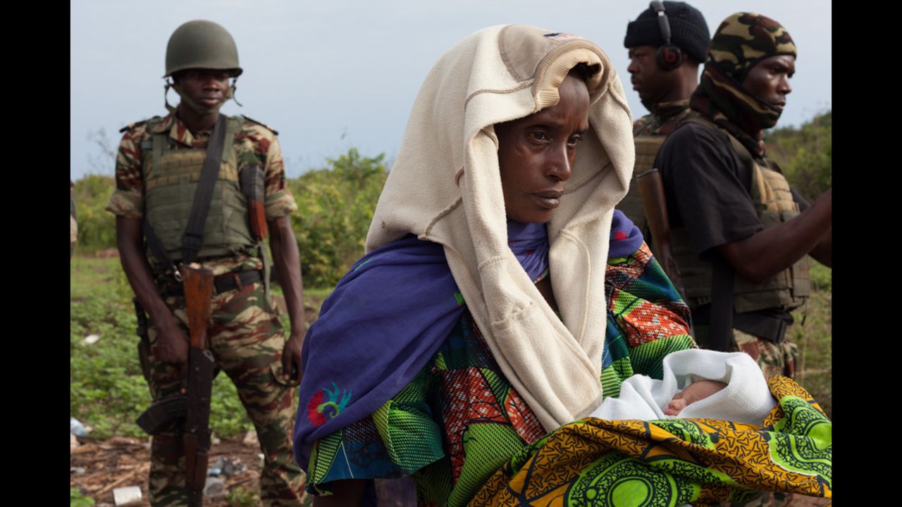 A woman holds one of the newborn babies near Kaga Bandoro as the convoy prepares to leave on April 29.