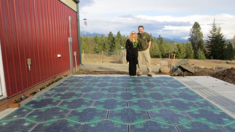 Solar Roadways co-founders Julie and Scott Brusaw stand on their prototype parking lot. Their idea calls for solar-powered roadways made of durable textured glass.