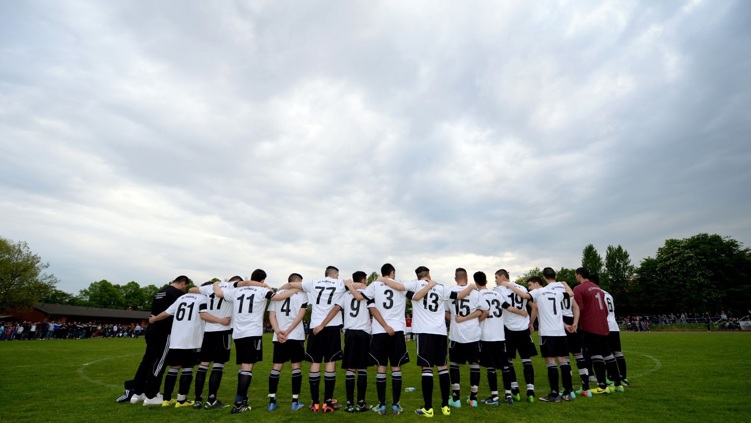 The teammates of Diren Dede holds a moment of silence before a soccer match in Hamburg, Germany. 
