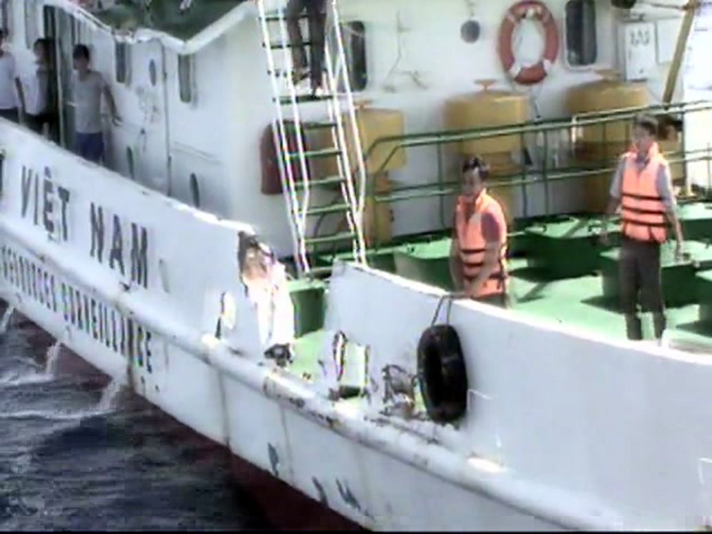 In this video image released by the Vietnam Coast Guard, Vietnamese surveillance ship crew members stand near the side of the ship, allegedly damaged after being rammed by a Chinese ship.