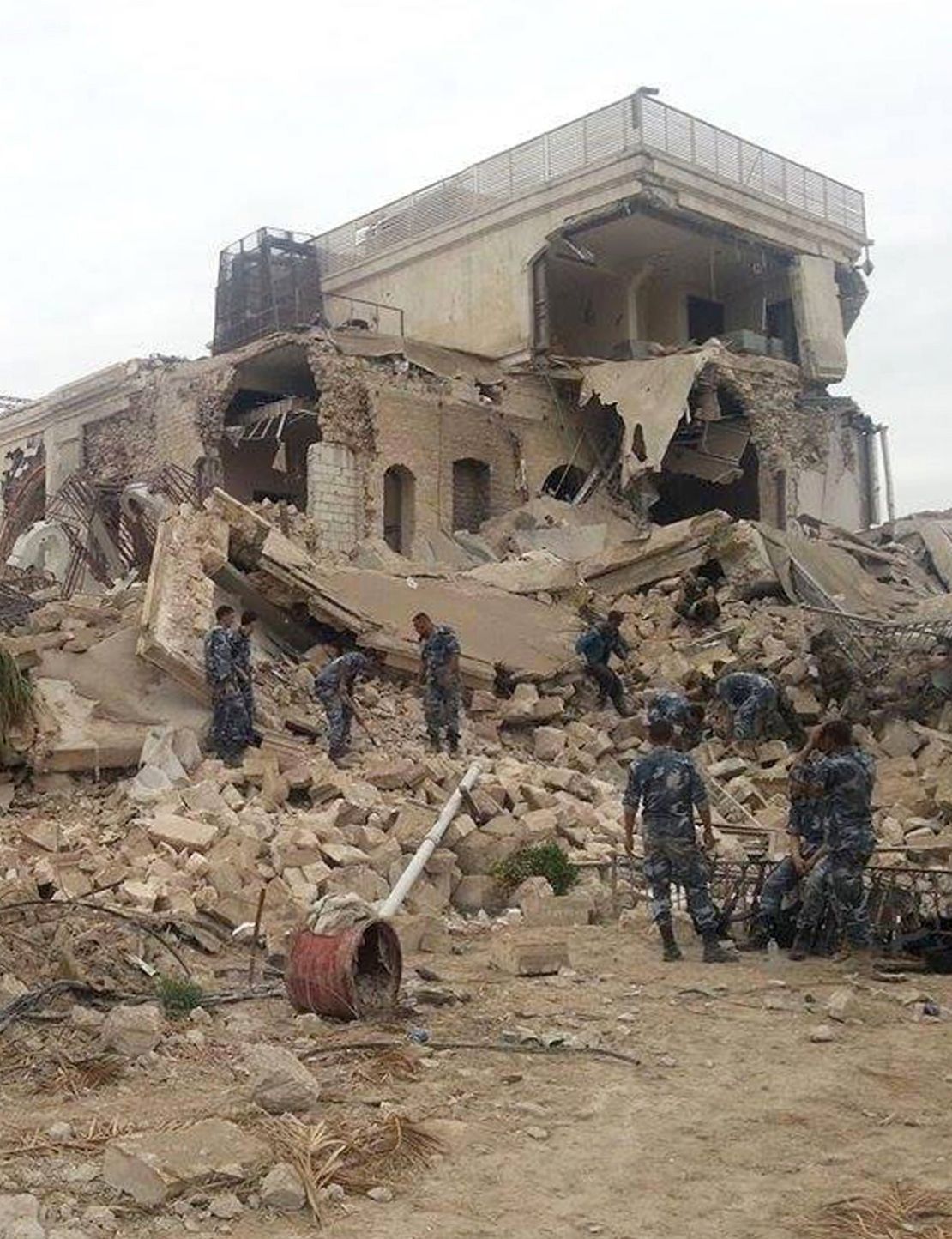 Syrian government forces sift through the rubble. 