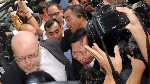 Thomas Kwok (C) is surrounded by the media and security as he arrives at court in Hong Kong on October 12, 2012.