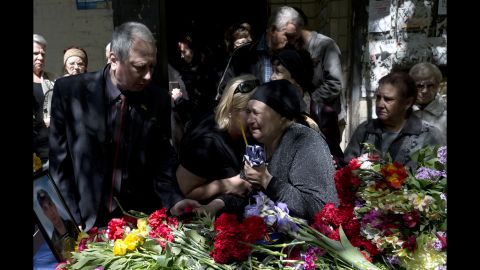 The mother of Dmitriy Nikityuk, who died in a fire at a trade union building during riots in Odessa, Ukraine, cries next to his coffin during his funeral on Thursday, May 8. 