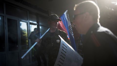 A pro-Russian activist stands with a Russian national flag outside the regional Interior Ministry building in Luhansk on Wednesday, May 7.
