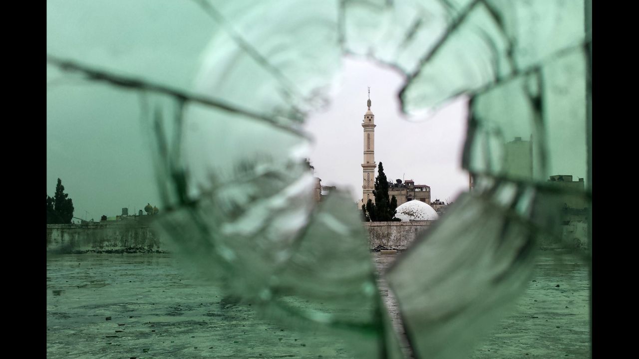 A mosque is seen through shattered glass in Homs, where an evacuation truce went into effect on Wednesday, May 7. 