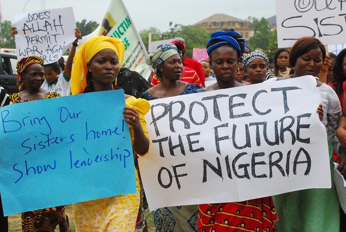 Women hold banners during a march of Nigeria women and mothers of the kidnapped girls of Chibok in Abuja