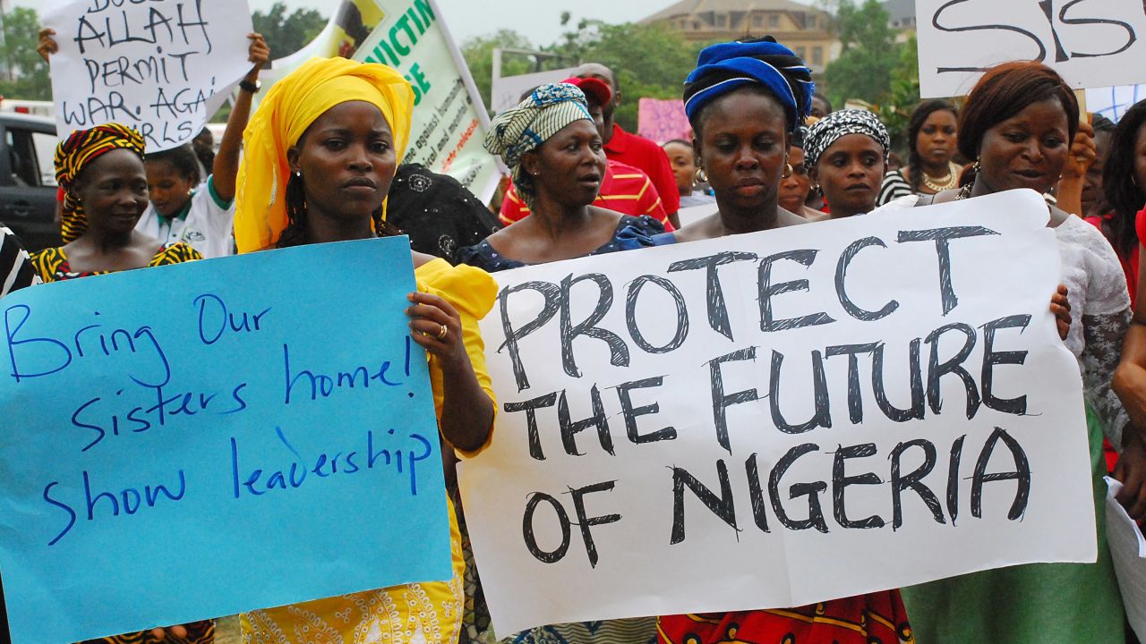 Women hold banners during a march of Nigeria women and mothers of the kidnapped girls of Chibok in Abuja