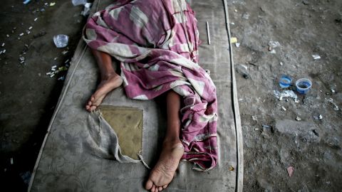 A drug user rests beneath an overpass in a Rio shantytown.