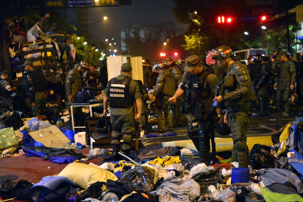 Venezuelan National Guard personnel in riot gear dismantle a students' encampment in front of the U.N. headquarters in Caracas on May 8. 