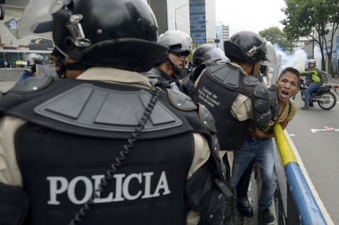 Venezuelan riot police arrest a student taking part in an anti-government protest in Caracas on May 8.