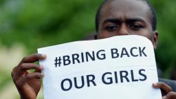 A participant at the World Conference on Youth 2014, holds a placard during a protest to demand the return of hundreds of school girls abducted by the Boko Haram separatist group in Colombo on May 9, 2014.