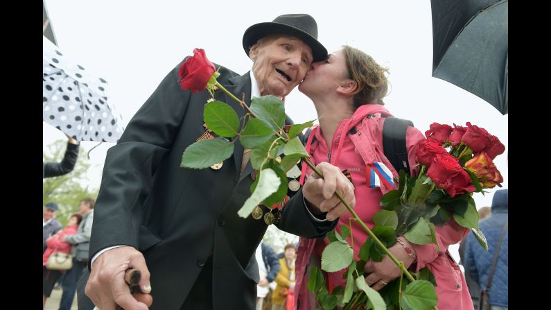 A woman kisses a World War II veteran in Riga, Latvia, on Friday, May 9, as the country's large Russian minority gathered to celebrate Victory Day, the anniversary of Nazi Germany's surrender to the Soviet Union.