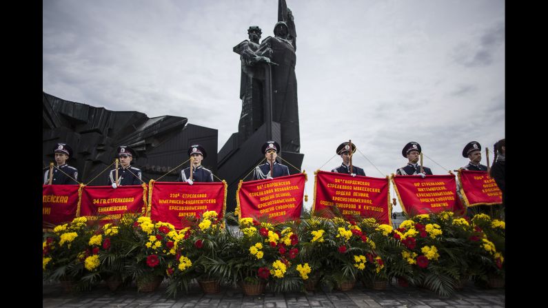 Ukrainian police officers stand behind banners during a ceremony in Donetsk, Ukraine.