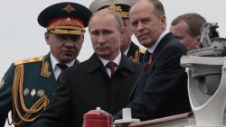 Russian President Vladimir Putin, flanked by Defense Minister Sergei Shoigu, left, and Federal Security Service Chief Alexander Bortnikov, right, arrives a Victory Day celebration after inspecting battleships in Sevastopol, Crimea.