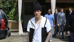 Justin Bieber squints as he makes his way to fans outside of a Four Seasons in Beverly Hills on May 8.