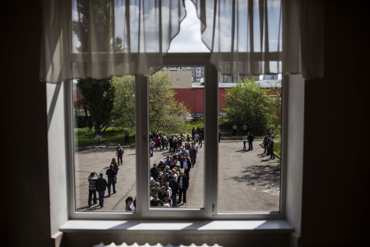 Ukrainians line up to cast their votes at a polling station in Donetsk on May 11.