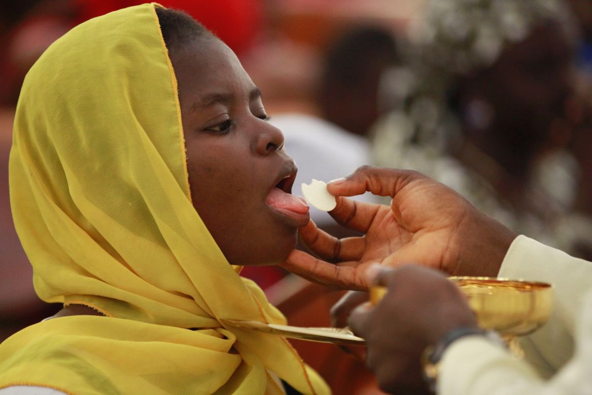Catholic faithful in Abuja take Holy Communion and pray for the safety of the kidnapped schoolgirls on Sunday, May 11.