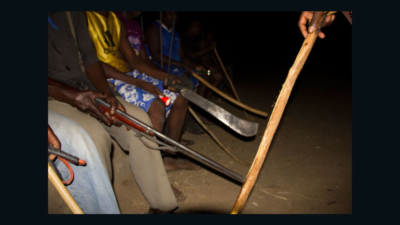 Men with guns and machetes on patrol to protect the village.  They did not want their faces shown.