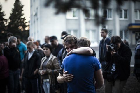 Two men react after Ukrainian national guardsmen open fire on a crowd outside a town hall in Krasnoarmiysk, Ukraine, on May 11.