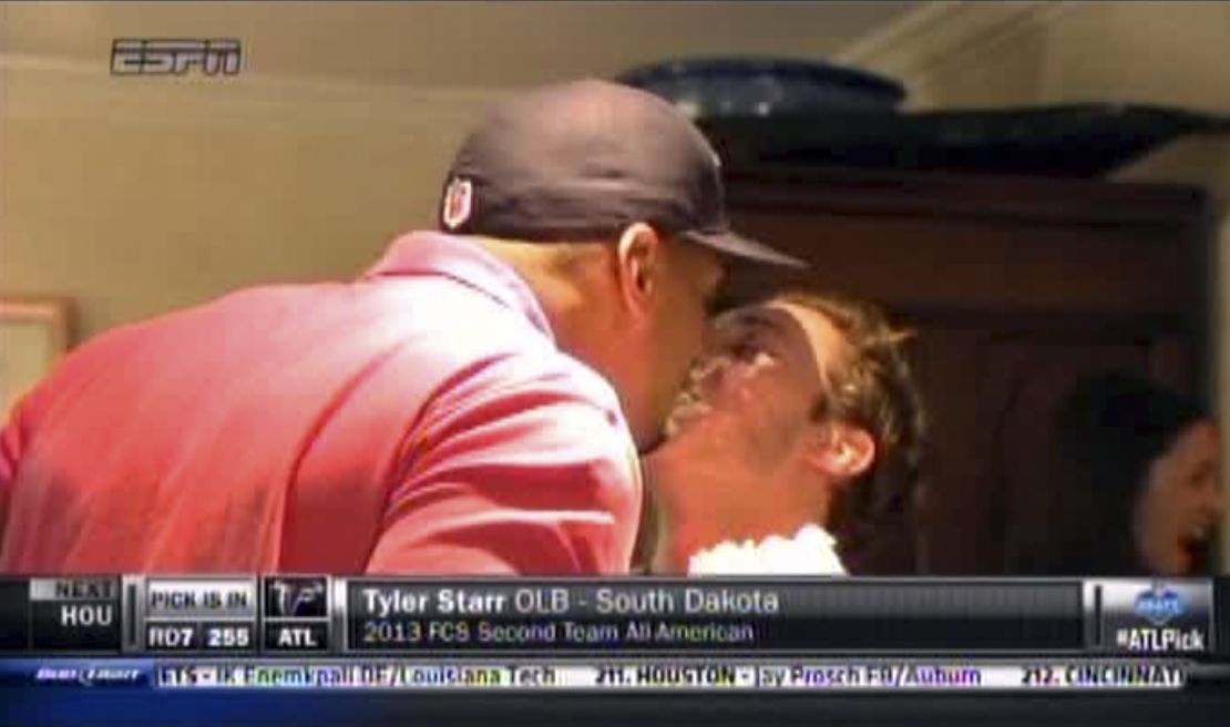 In an image taken from video, Michael Sam, left, and boyfriend Vito Cammisano kiss at an NFL draft party in San Diego. Sam was selected in the seventh round, 249th overall, by the St. Louis Rams.