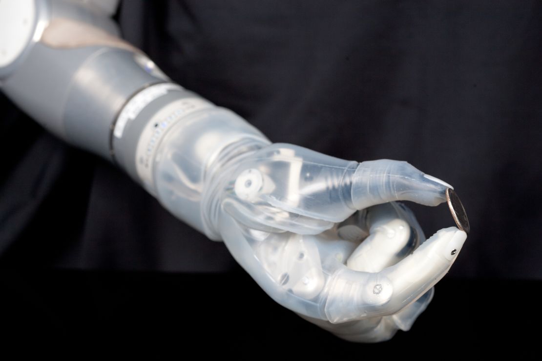 The DEKA bionic arm can control multiple joints simultaneously to pick up small objects such as this coin.
