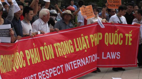 Vietnamese protesters hold a rally in Hanoi Sunday against a Chinese oil rig deployed in disputed waters of the South China Sea.