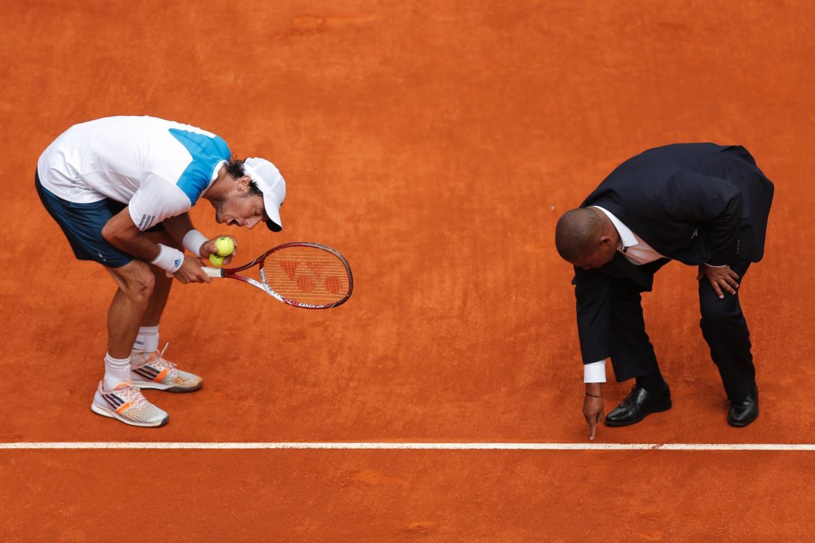 Juan Monaco from Argentina, left, discusses a point with umpire Carlos Bernardes during a Madrid Open tennis match against Rafael Nadal from Spain on Wednesday, May 7. Nadal won 6-1, 6-0.