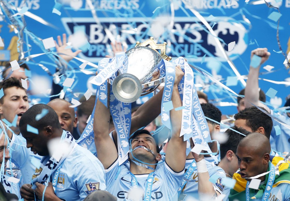 Sergio Aguero of Manchester City lifts the Premier League trophy at the end of the Barclays Premier League match between Manchester City and West Ham United at Etihad Stadium in Manchester, Britain, on Sunday, May 11. Manchester City claimed their second Premier League title in three seasons after beating West Ham United 2-0.