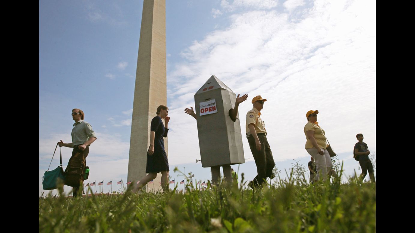 Steven Avilla wears a Washington Monument costume as he greets visitors.