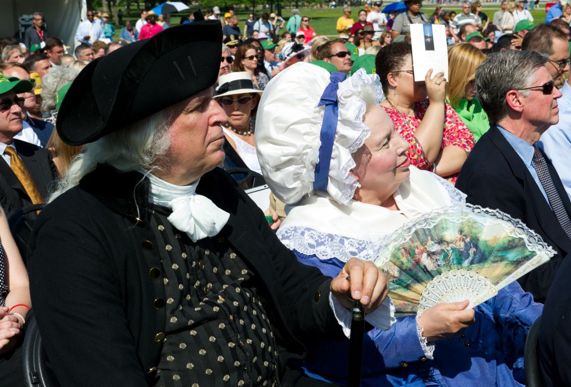 Re-enactors portraying President George Washington and his wife, Martha, attend the reopening celebrations. Built as a tribute to Washington's military leadership during the American Revolution, construction of the Washington Monument was started in 1848 and completed in 1884.